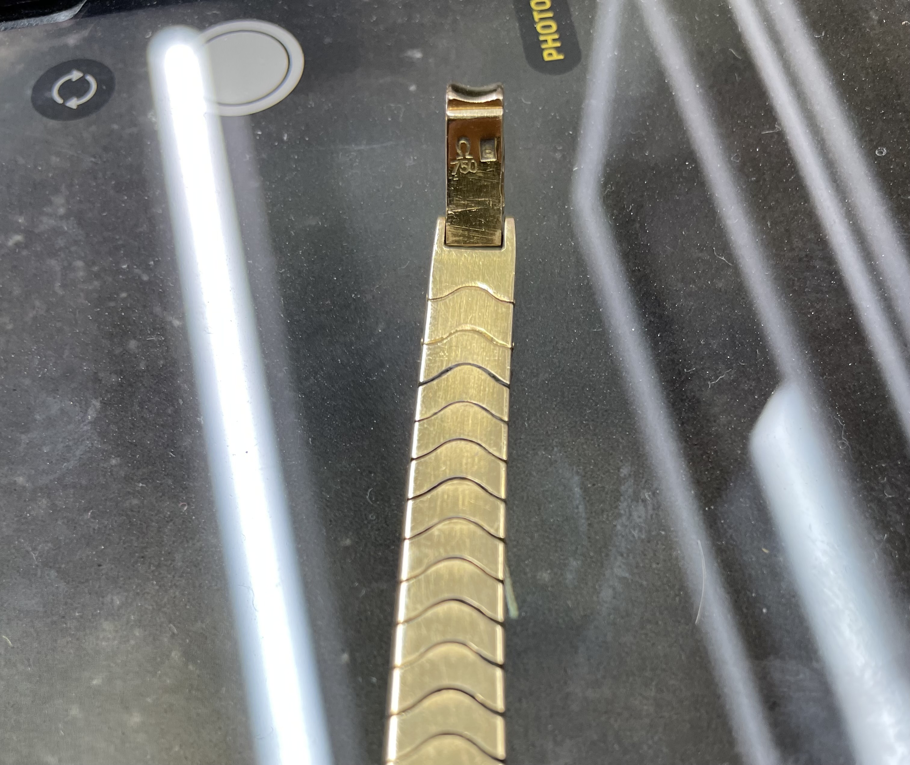 A lady's yellow metal, stamped 750, Omega Ladymatic wrist watch, on a 750 bracelet, length 17.cm, gross weight 38.9 grams.